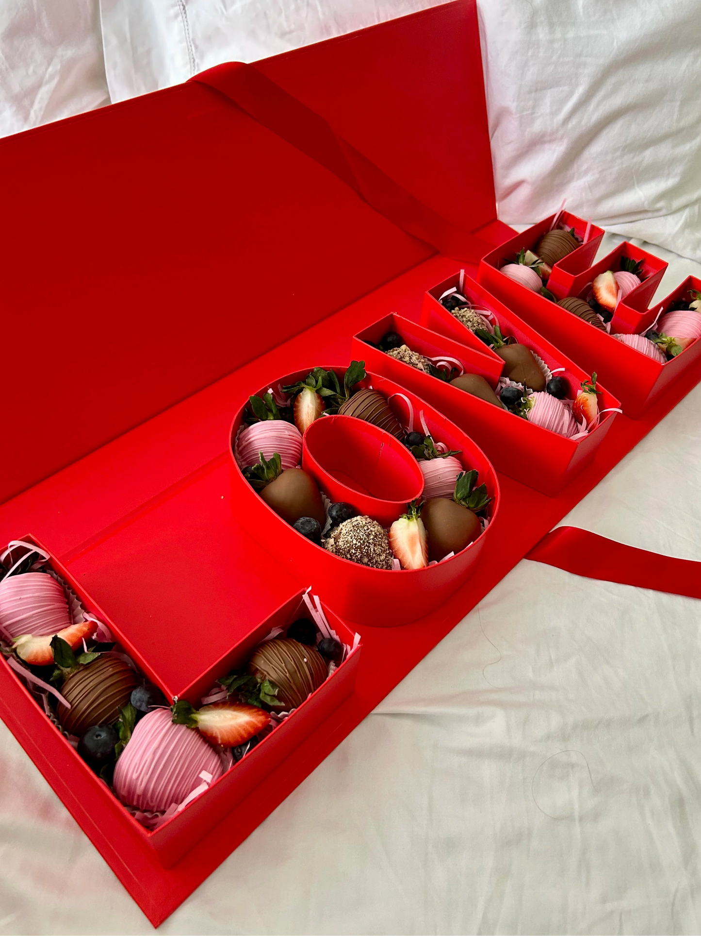 luxury red gift box with chocolate covered strawberries