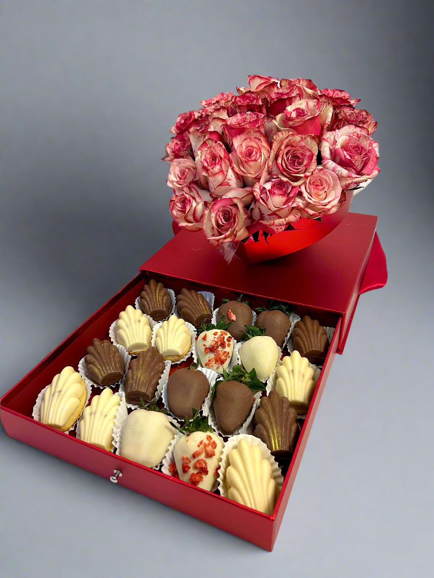 red gift box with roses and chocolate dipped strawberries and Madeleines