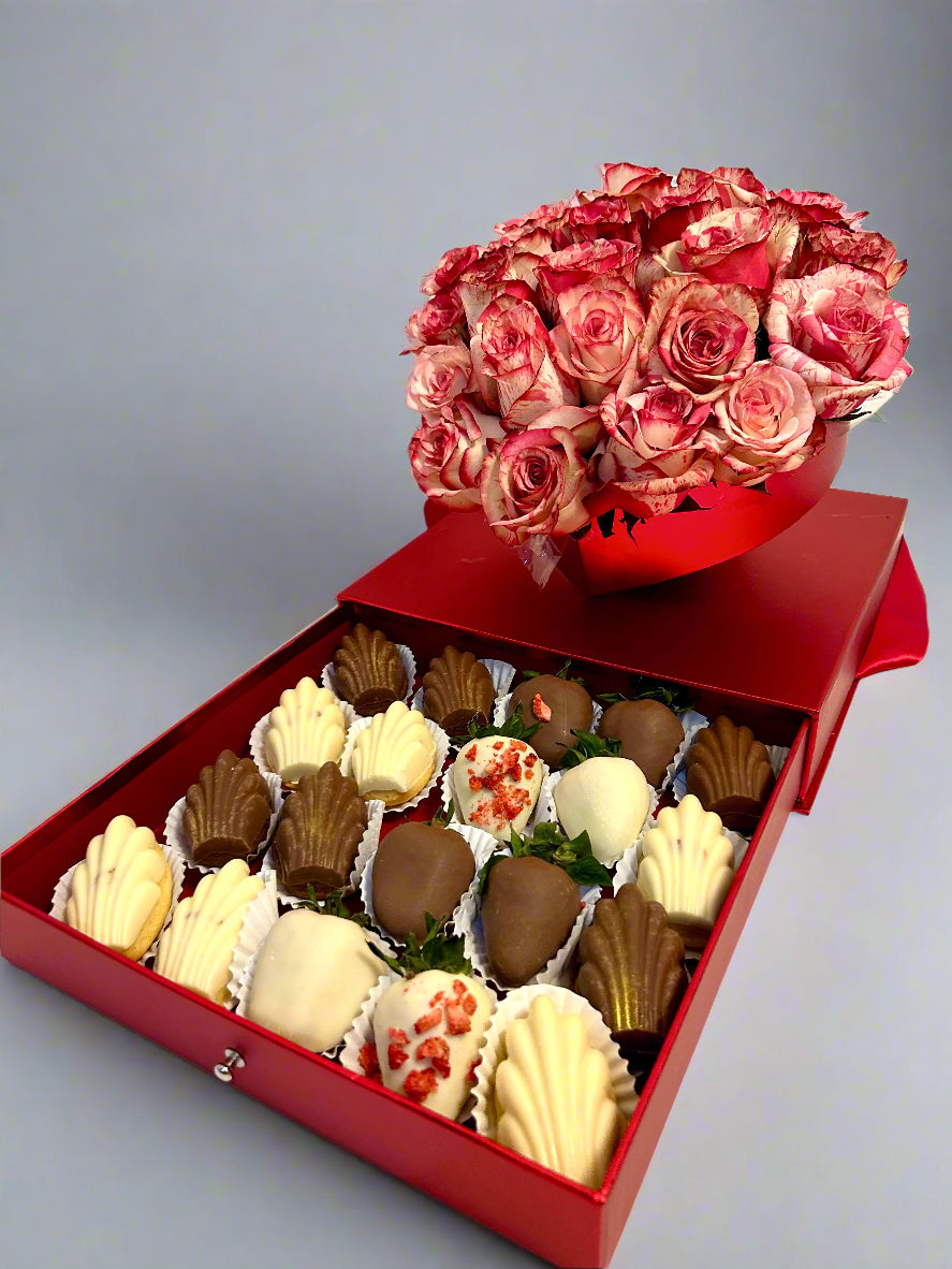 red box with roses and chocolate dipped strawberries and Madeleines